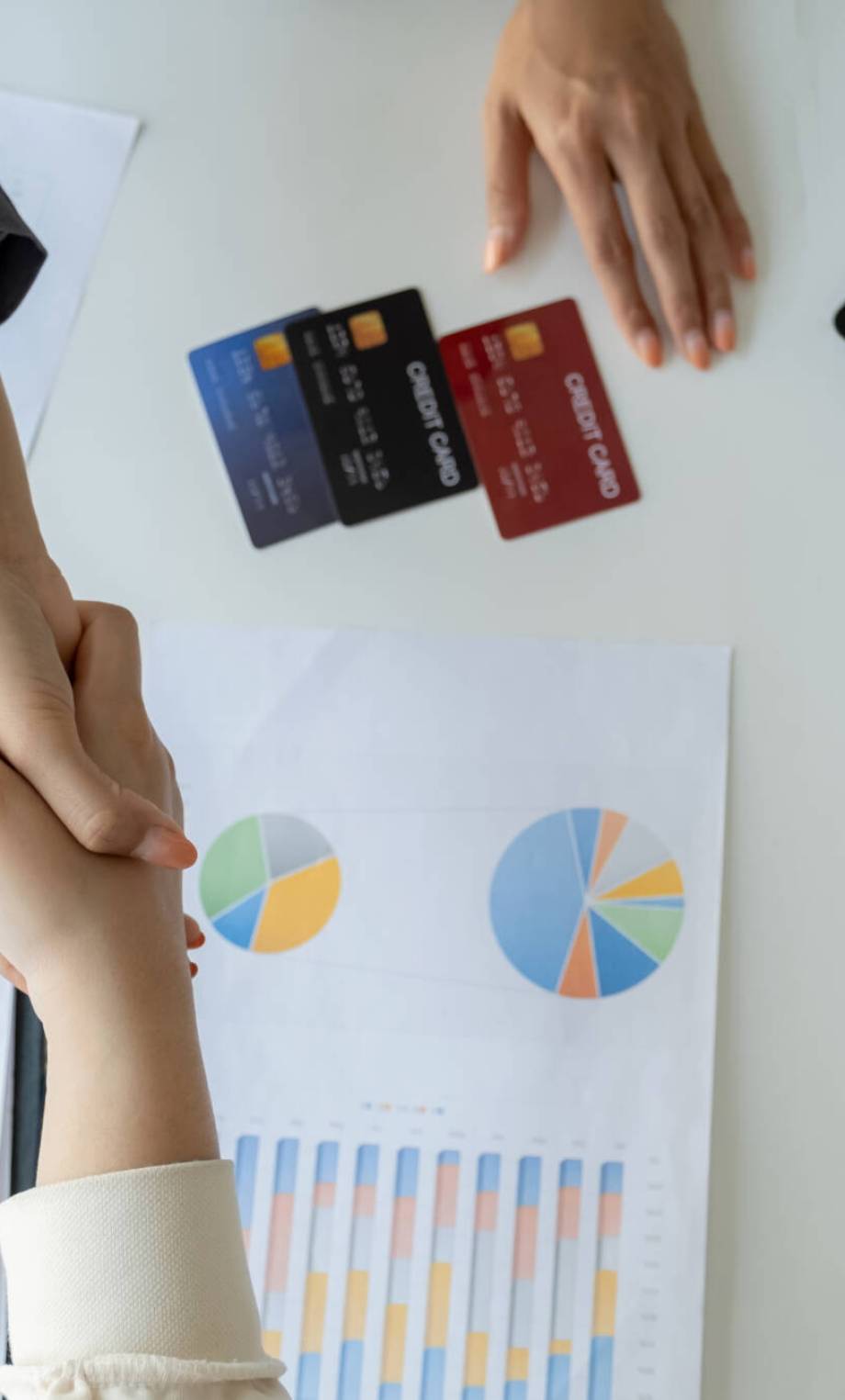 Hand shake after Employees present with mock up credit card payments to business customers. Ready to provide discounts and life insurance.